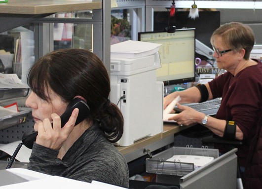 two EMS employees working in an office